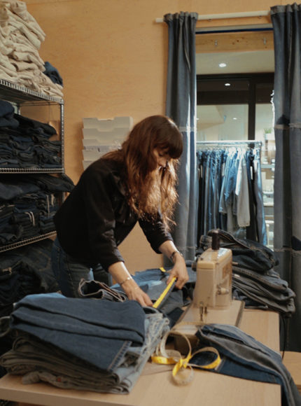 Anna Foster tailoring a pair of ELV denim