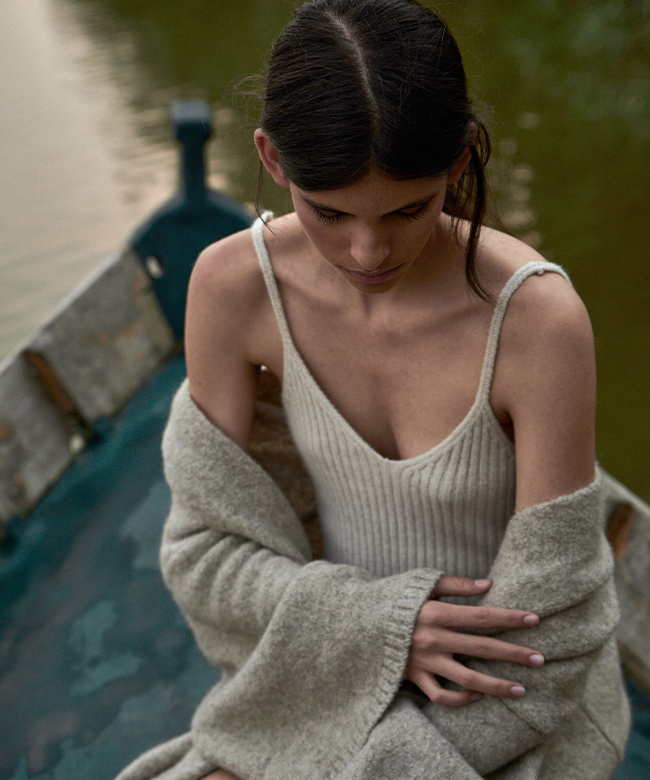 leap-cashmere-knitted-bodysuit-ecru-editorial-portrait-photograph-on-a-boat