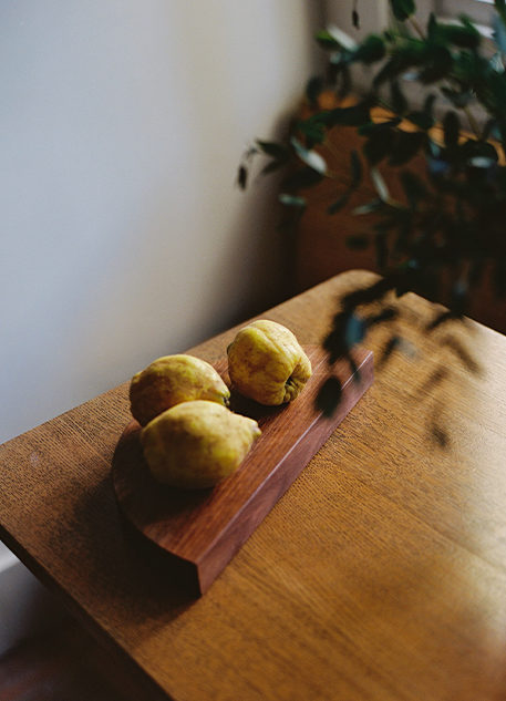 fanny-singer-editorial-interview-scroll-image-lemons-on-table-with-leaves-out-of-focus-in-front