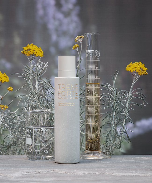 irene-forte-natural-skincare-product-lifestyle-image-product bottles-with-yellow-flowers-behind