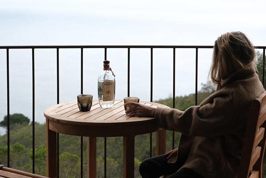 Drinking on a balcony overlooking the pacific ocean