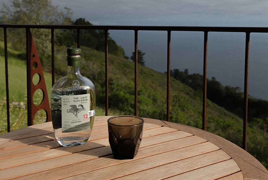 Bottle and glass on a balcony table