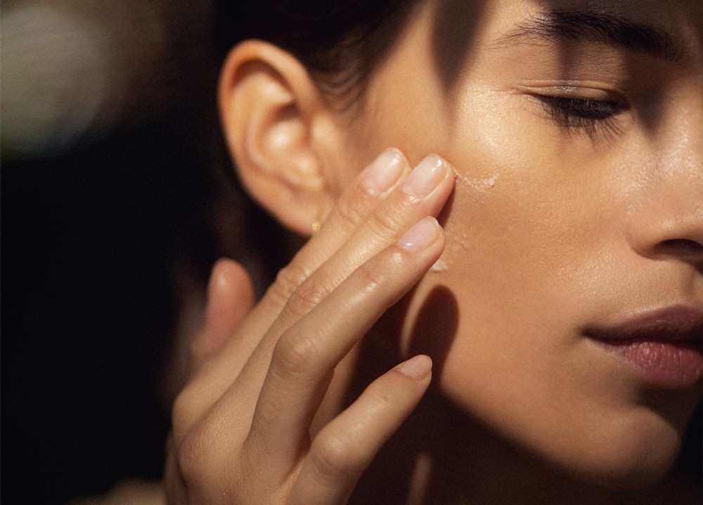 model practicing summer solstice skincare rituals