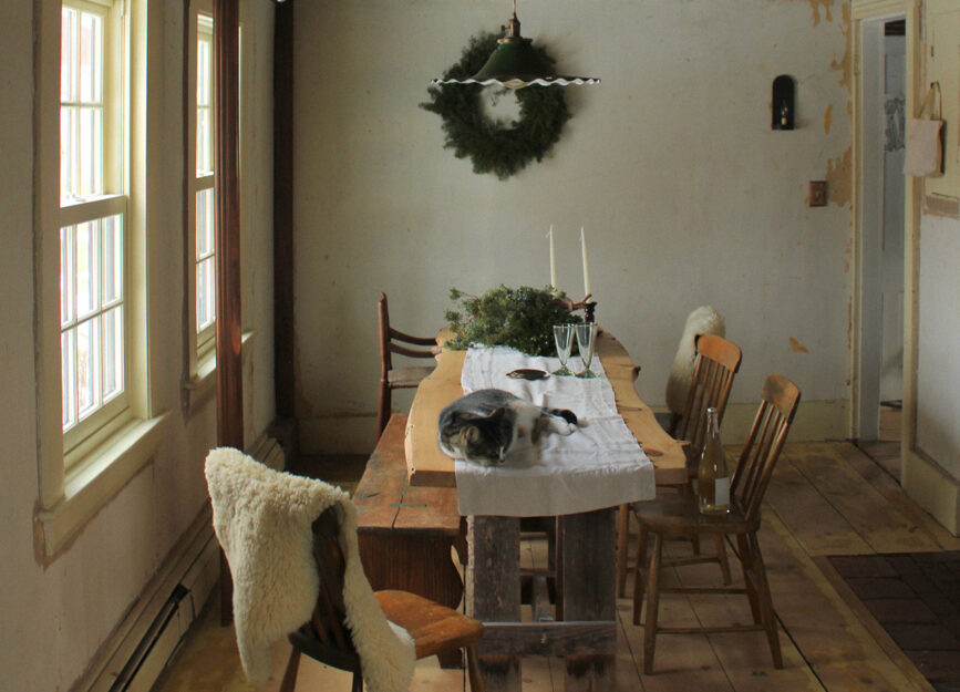 Table of foraged Christmas decorations on a table in Maine.