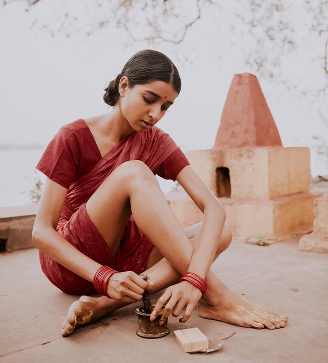 blending Ayurvedic ingredients in a mortar and pestle