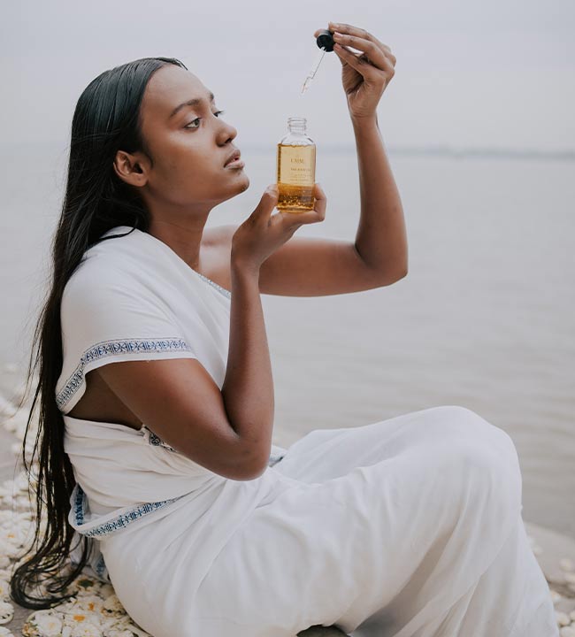 lady during a bathing ritual using UMM's Ayurvedic skincare products