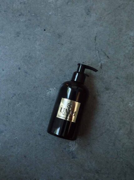 UMM Ayurvedic body wash and cleanser on a table