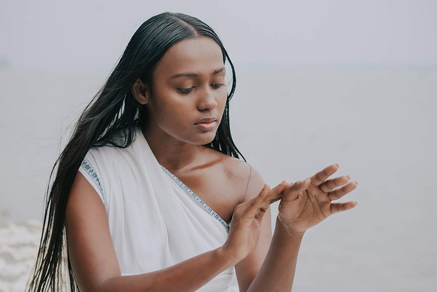 Women exploring the meaning of Ayurveda besides a river
