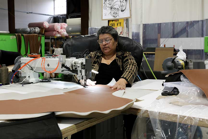 A Kindred worker at their factory in California. Every one of their electric car conversions is made in America.