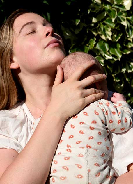 Mother holding baby in the garden