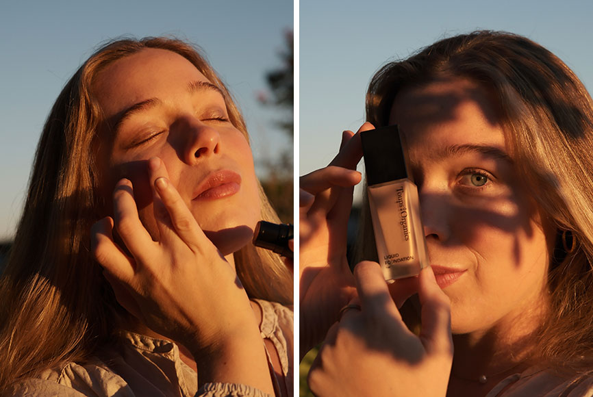 A woman holding up organic makeup to her face