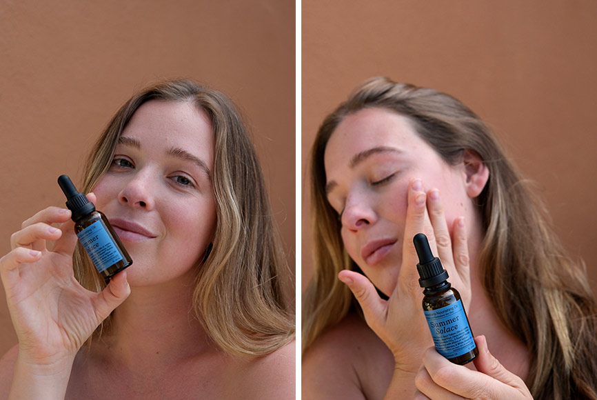 A woman using tallow face oil against an orange wall