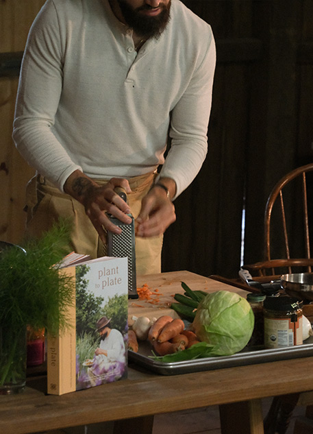Gaz Oakley grating vegetables on a table