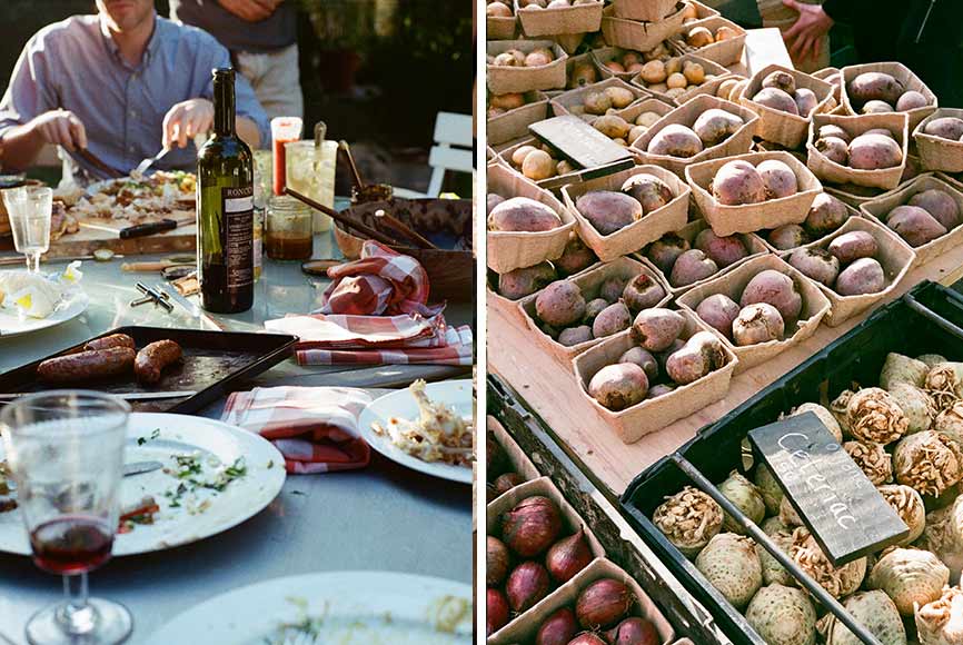 A family eating together at a large dinner table al fresco