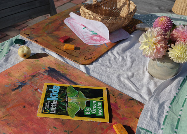 Coloring boards on a table with a magazine and crayons