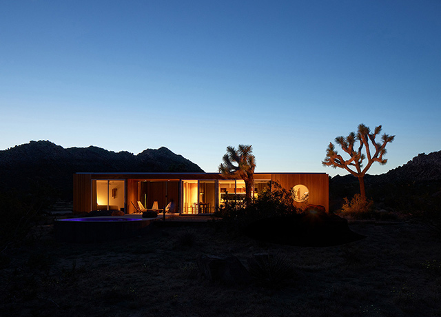 A house in the desert lit up at night