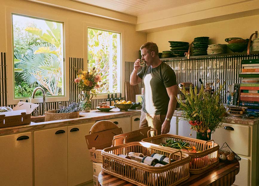 A man drinking coffee in the kitchen at the Flamingo Estate in LA