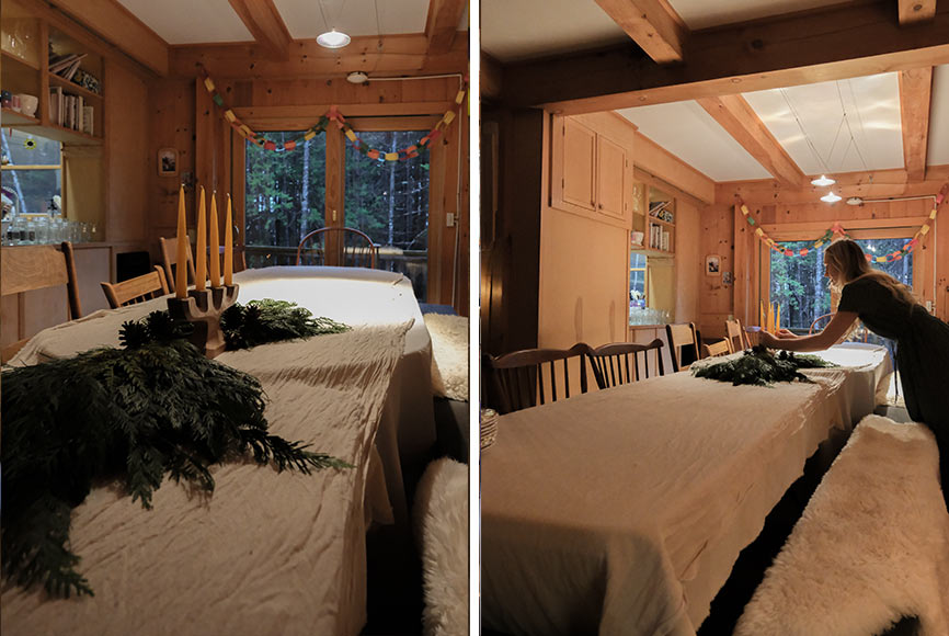 A woman setting a table with winter decor