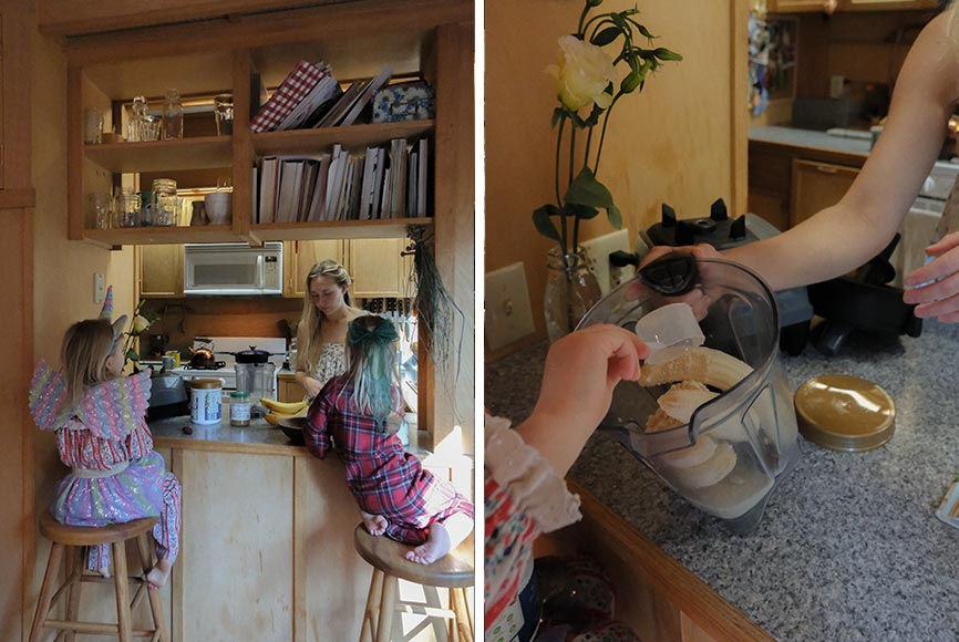 A mother making her daughter smoothies in a kitchen