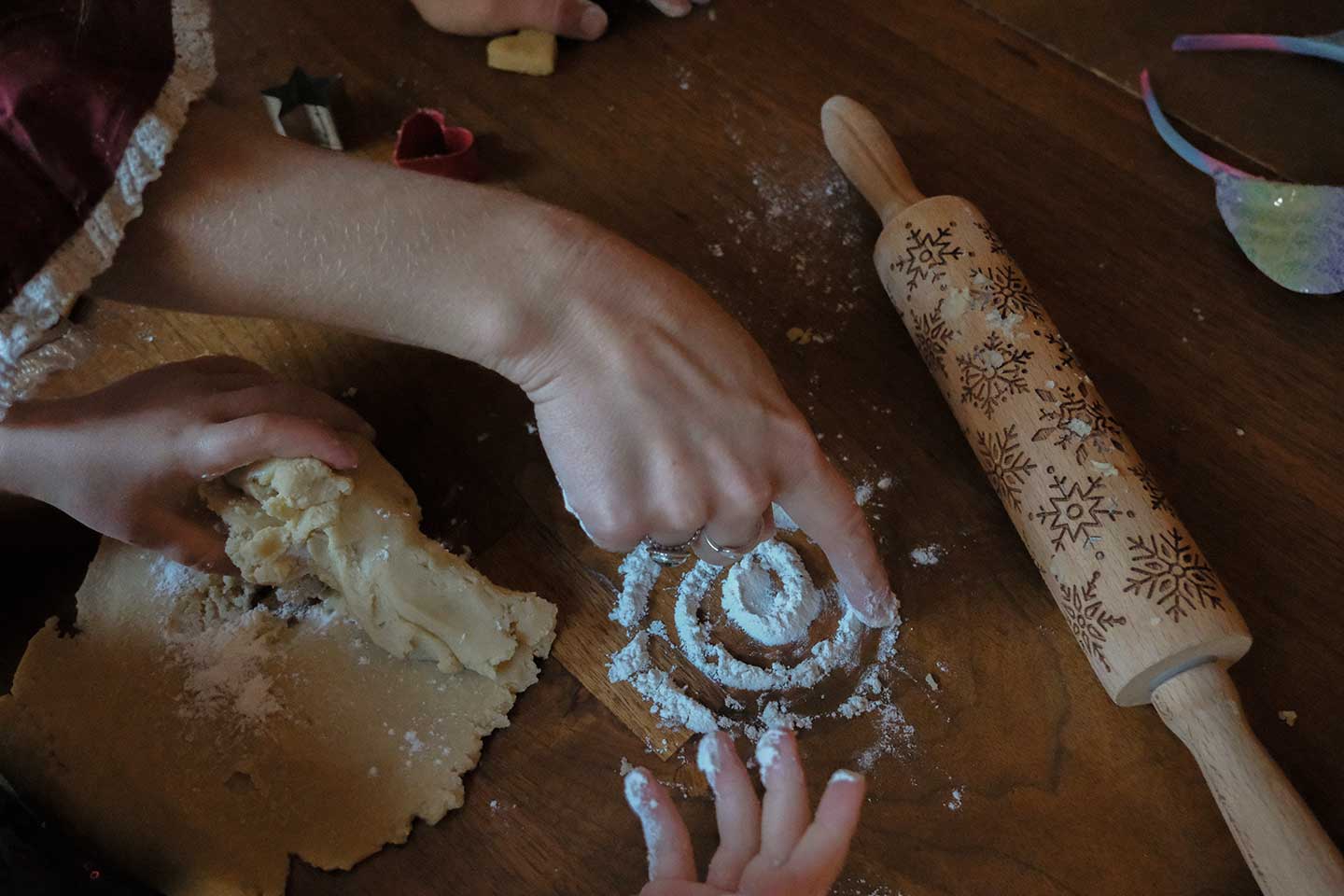 A woman drawing a circle in flour on a baking table