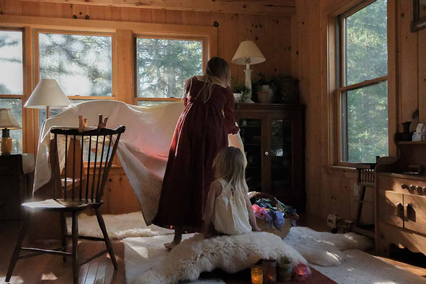A mother doing critical thinking activities for her children by building a fort