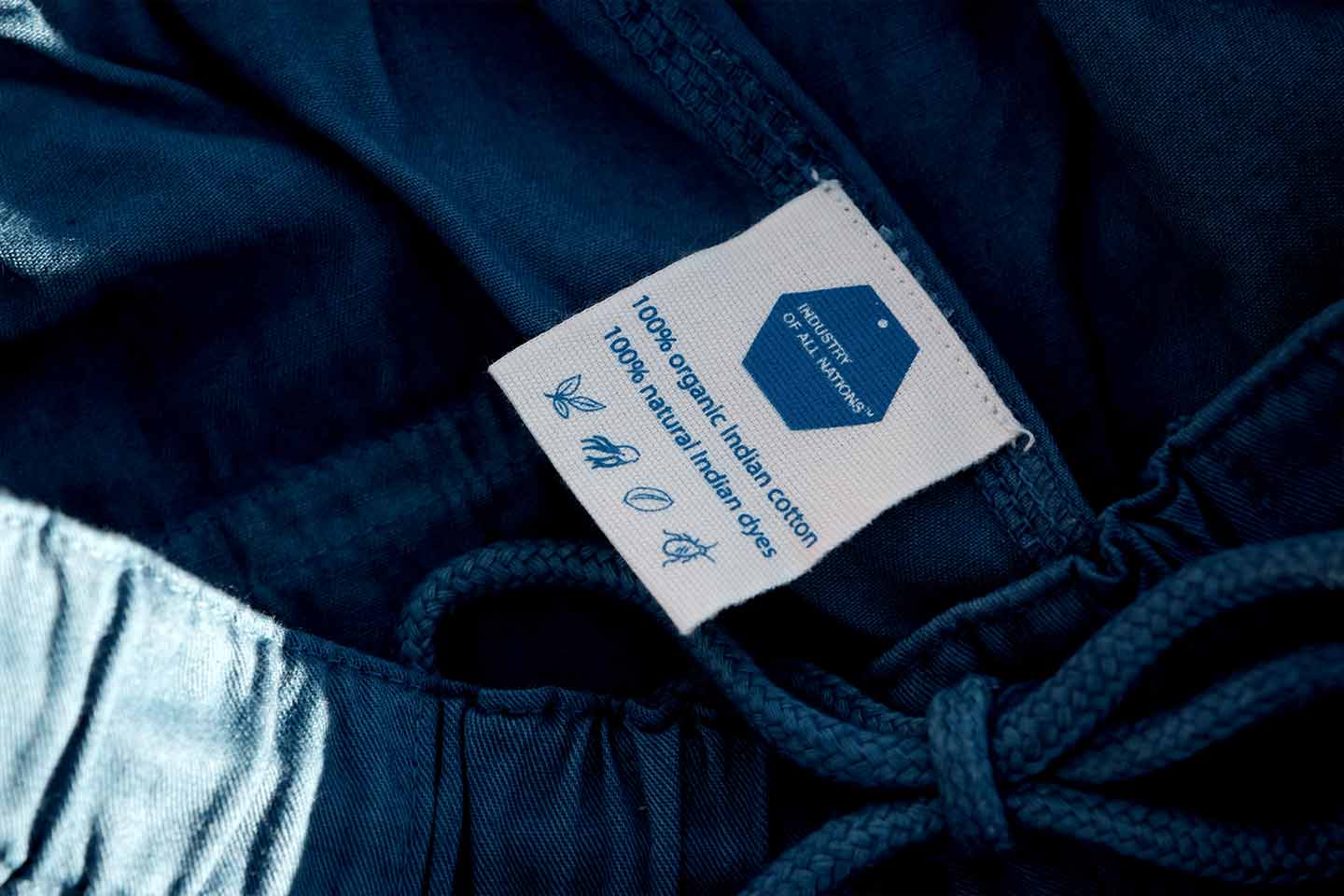 A close up of an indigo dyed drawstring pant