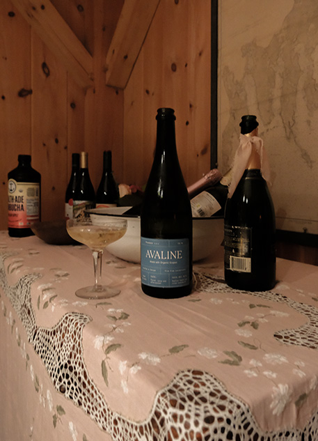 A bottle of Avaline Prosecco on a vintage pink tablecloth