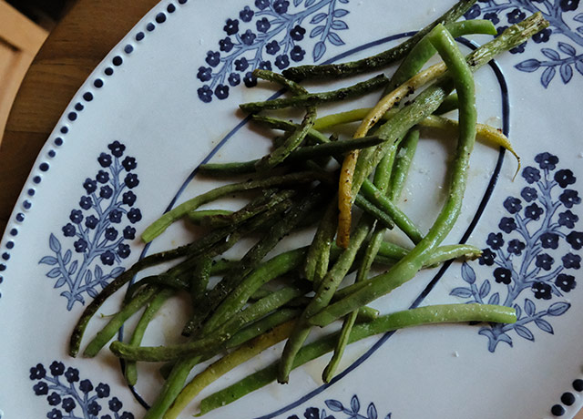 Sautéed green beans on a blue platter