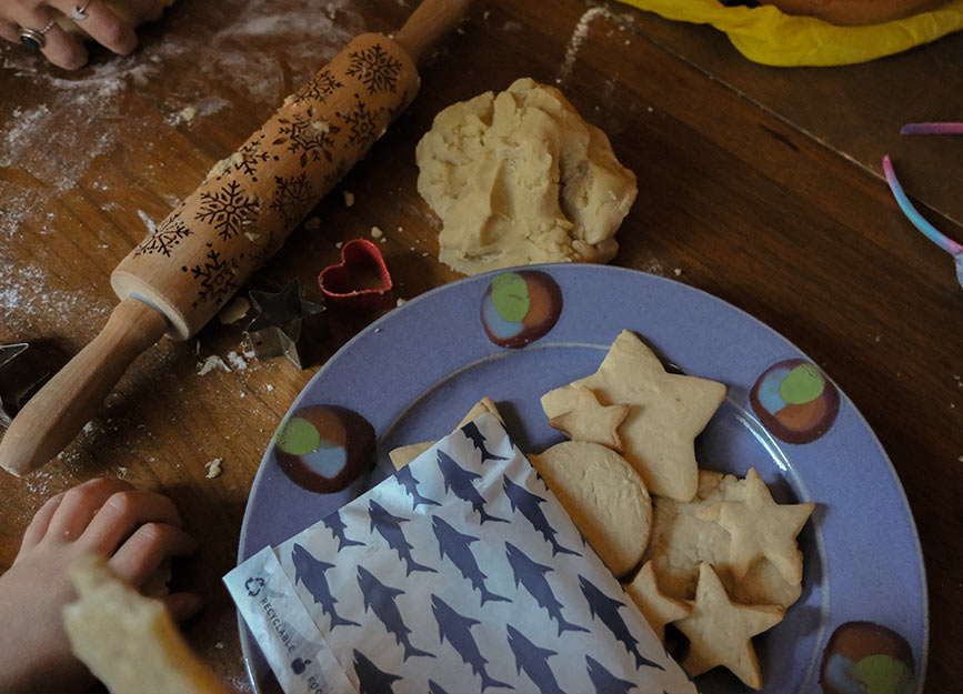 A blue plate full of star shaped cookies