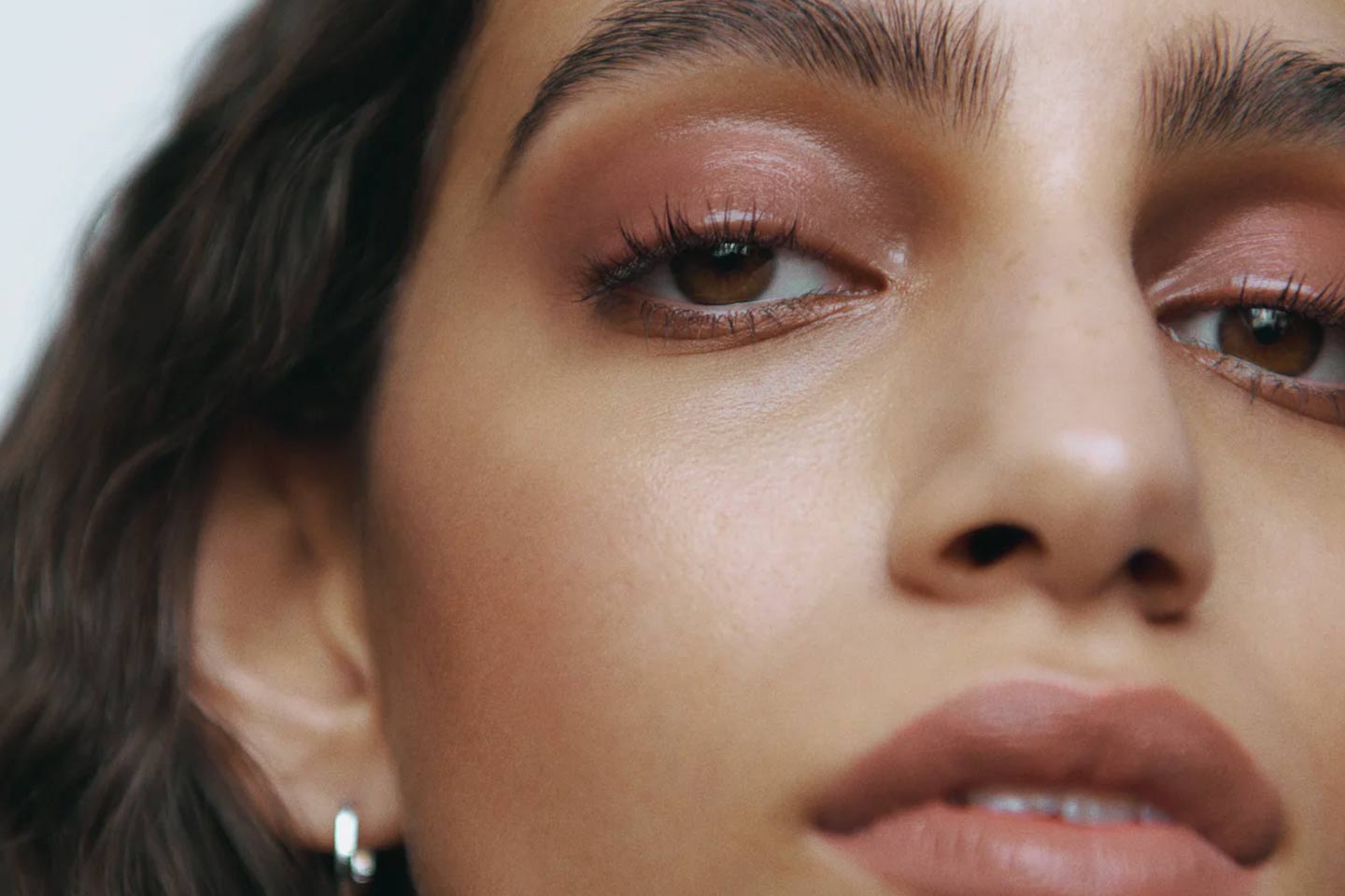 A close up of a woman wearing Manasi 7 mascara