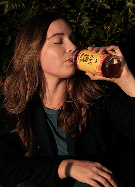 A woman drinking Yerba Madre tea