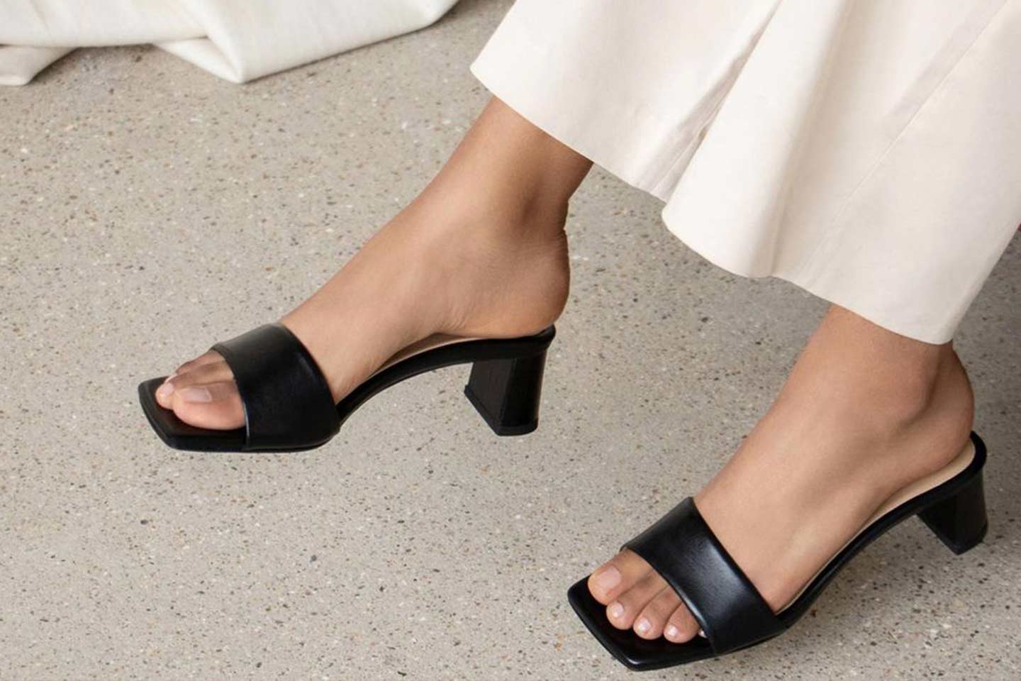 A woman's feet in black heeled shoes