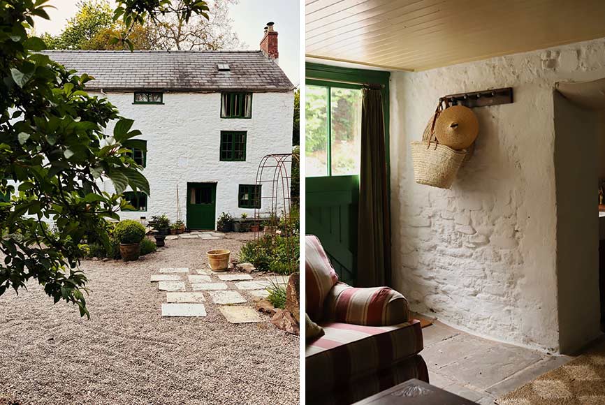 An old stone farmhouse with white walls and dark green trim