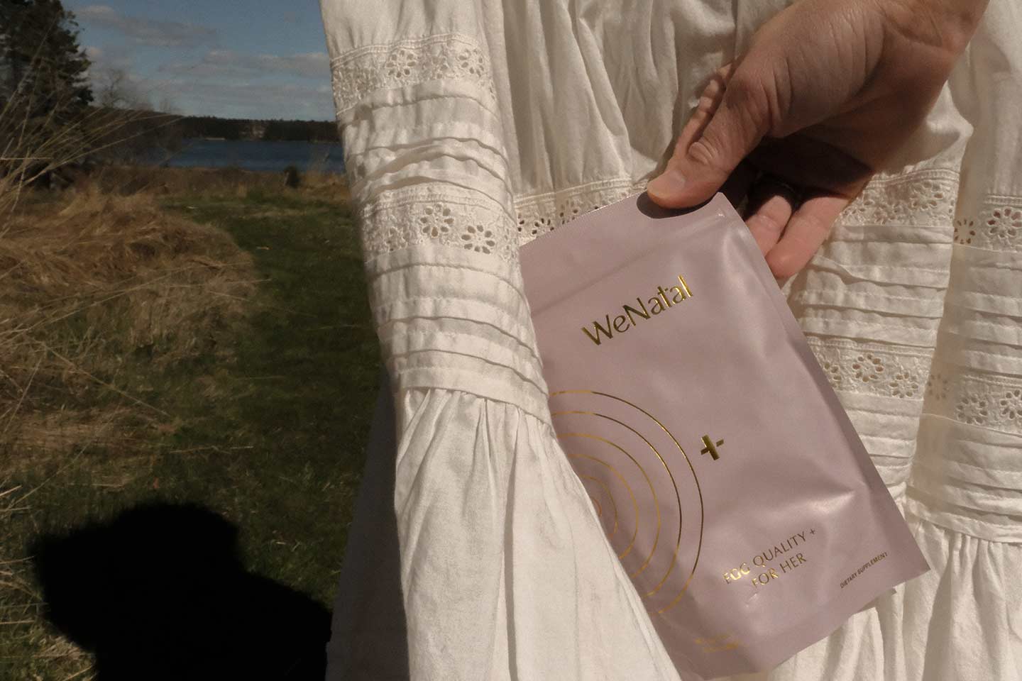 Wenatal supplements against a white lace dress