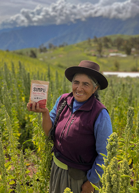 An older woman in Peru holding a bag of Simpli