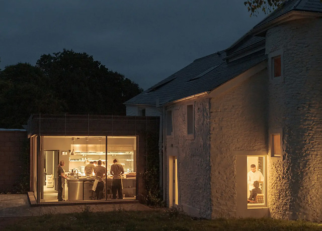 Osip restaurant illuminated at night showing the inside dining experience