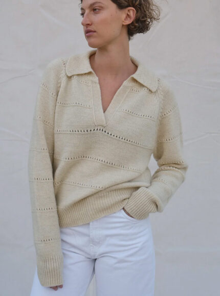 A woman in a cream wool jumper and white jeans